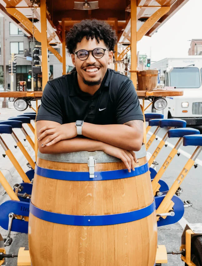 Pedal Pub franchisee smiling in front of a bike