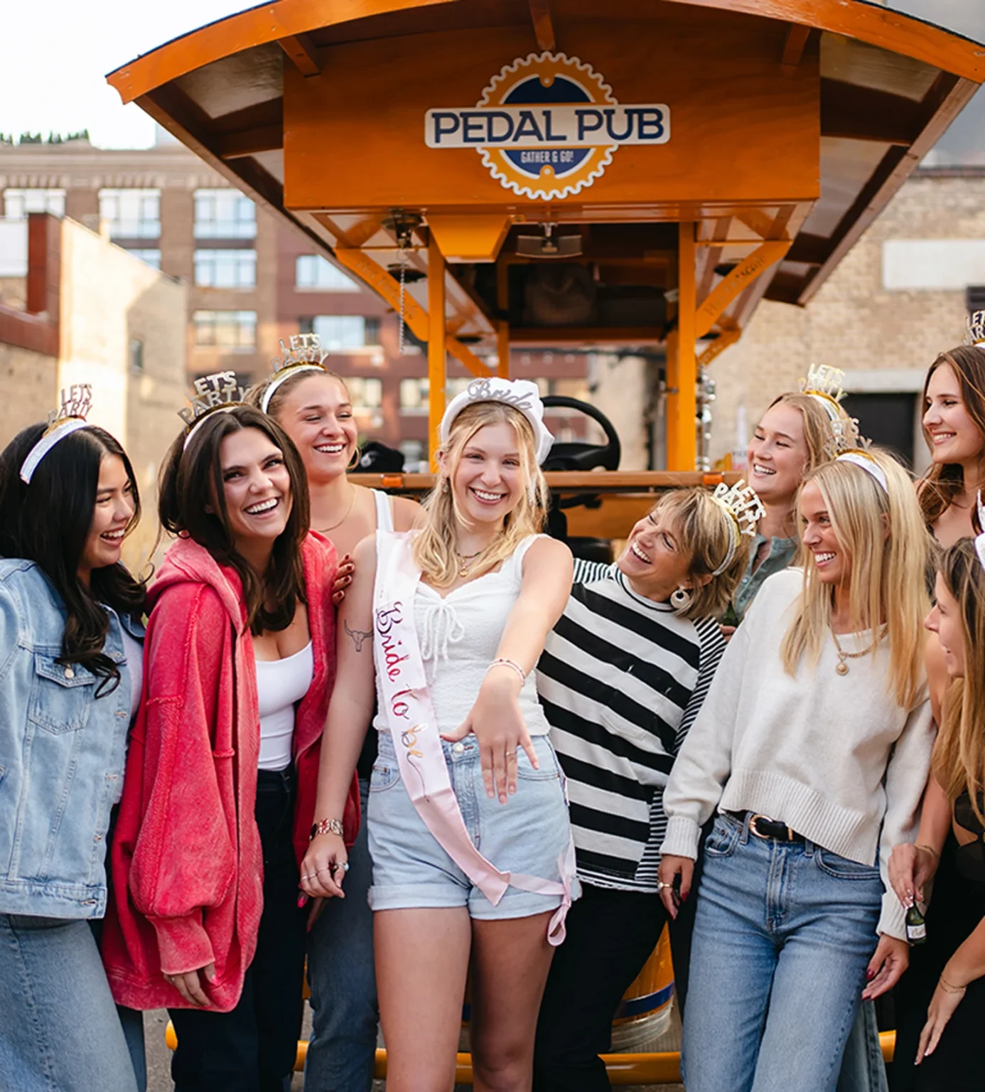 Group of friends celebrating a bachelorette party on a Pedal Pub