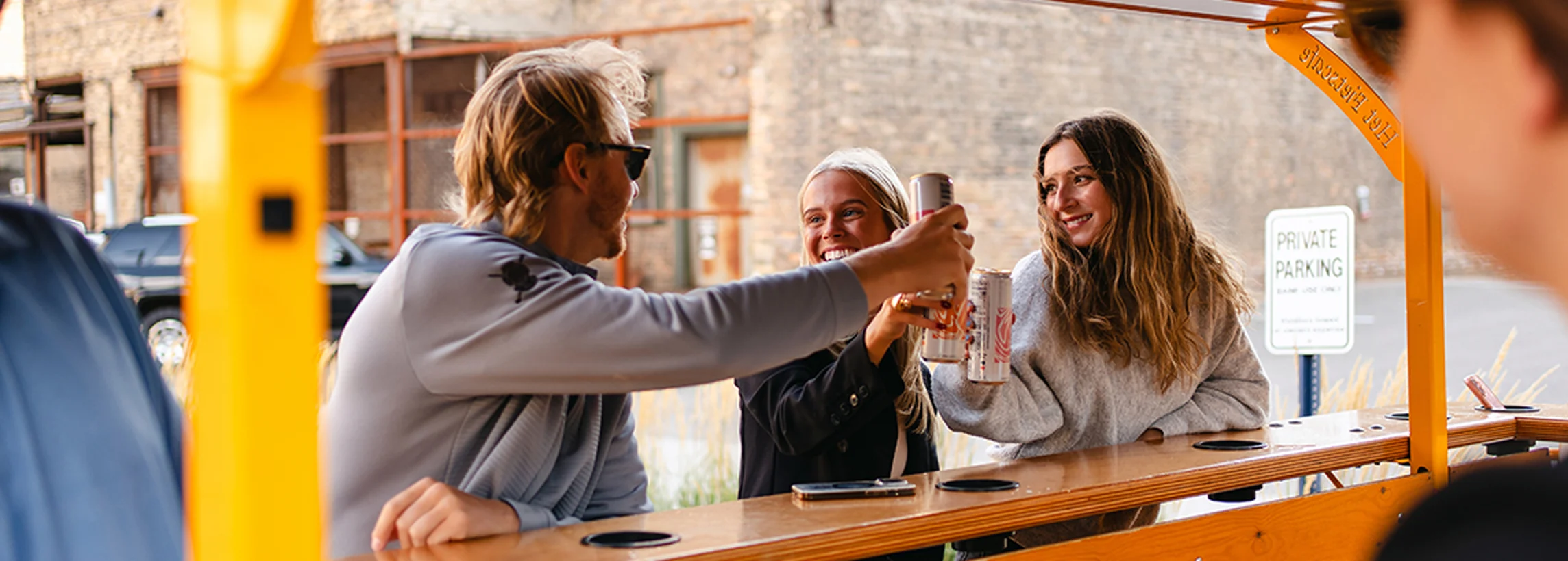 Coworkers clinking drinks on a Pedal Pub