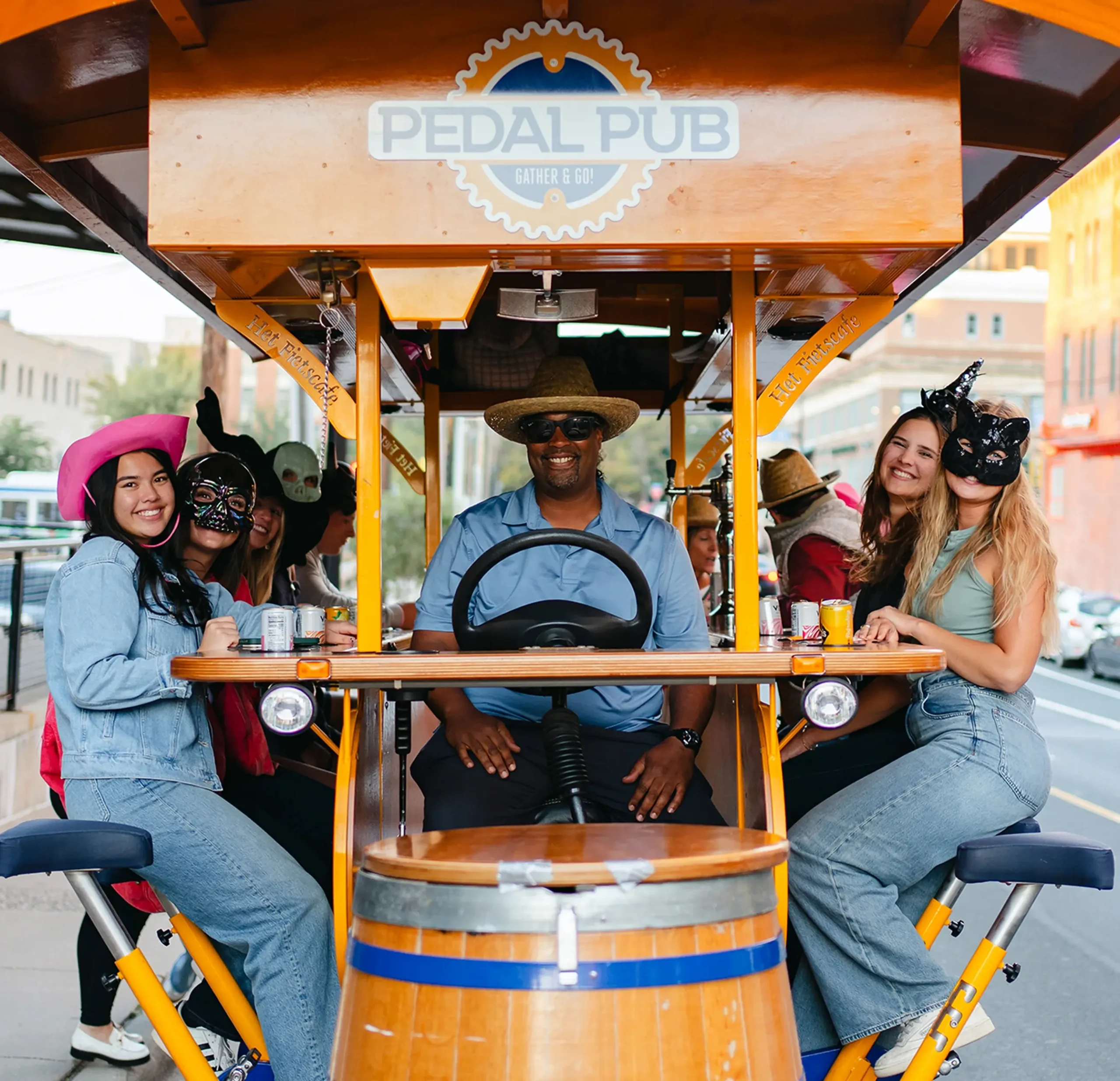 Guests laughing and having fun inside a Pedal Pub party bike