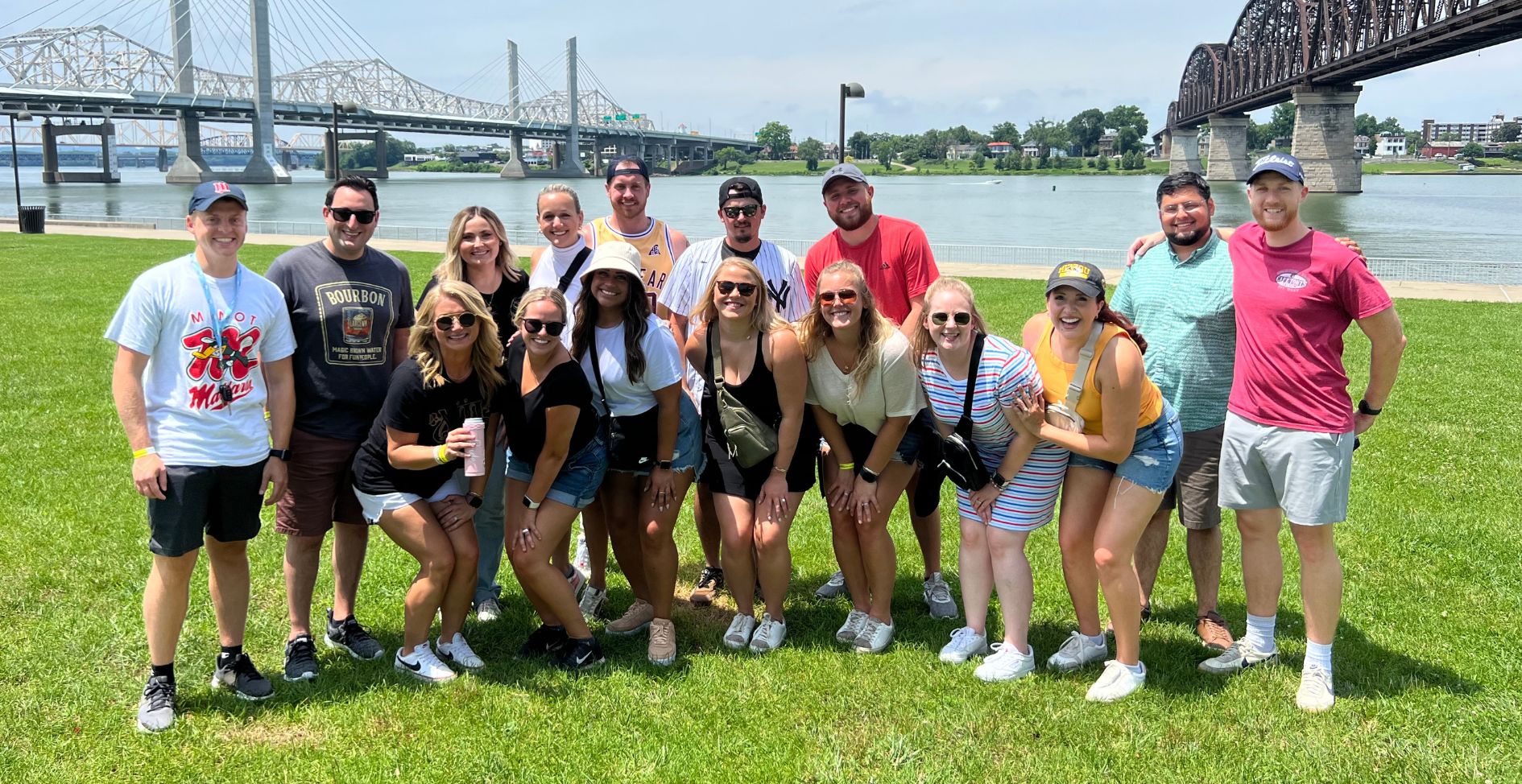 Pedal Pub Louisville tour group in front of city skyline