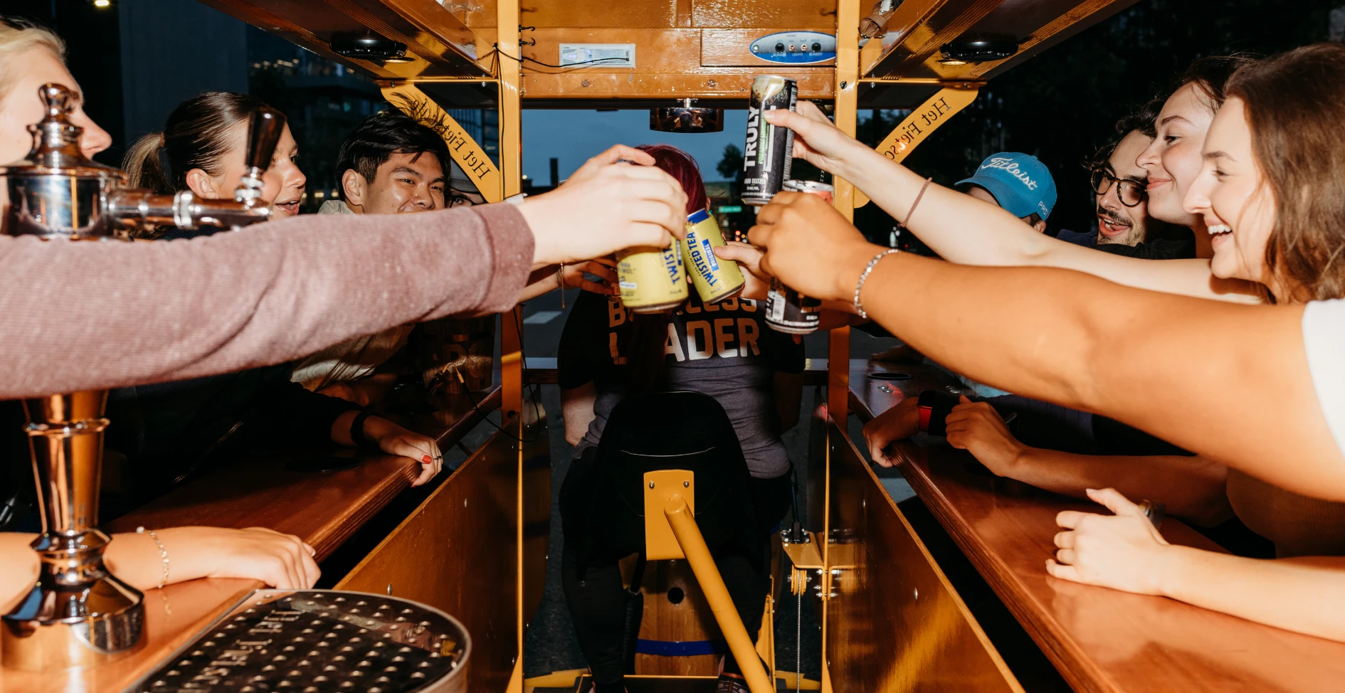 friends cheersing on party bike