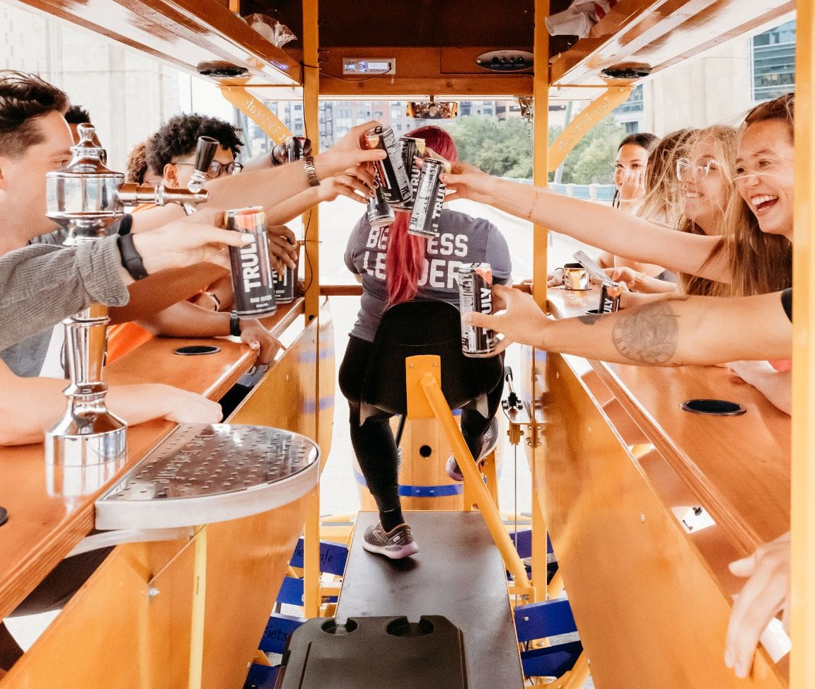 friends cheersing on party bike